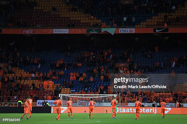 Fans leave in their droves to reveal plenty of empty seats as the Dutch players look dejected following their defeat in the UEFA EURO 2016 Qualifying...