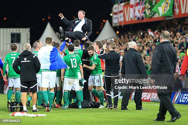 Northern Ireland manager Michael O'Neill is thrown into the air by the players as his side celebrate victory and qualification after the UEFA EURO...