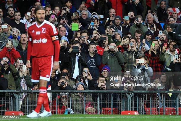 Fans take pictures of David Beckham of GB with their mobile phones and iPads during David Beckham's Match For Children, in aid of UNICEF, between a...