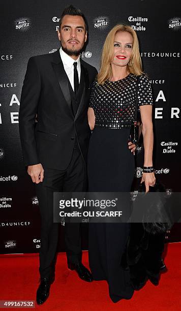 Manchester United's Argentinian goalkeeper Sergio Romero and his wife Eliana Guercio pose for pictures on the red carpet as they arrive to attend the...