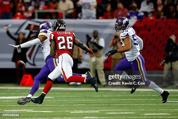 Anthony Barr and Antone Exum Jr. #32 of the Minnesota Vikings force a fumble by Tevin Coleman of the Atlanta Falcons at the Georgia Dome on November...