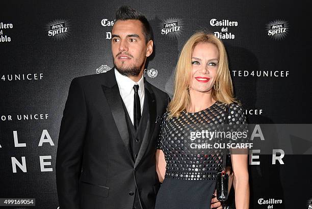 Manchester United's Argentinian goalkeeper Sergio Romero and his wife Eliana Guercio pose for pictures on the red carpet as they arrive to attend the...