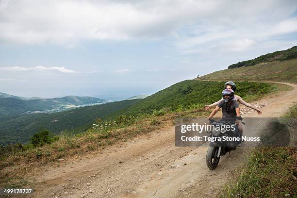 a couple on a motorcycle in the corsican hills. - cap corse stock-fotos und bilder