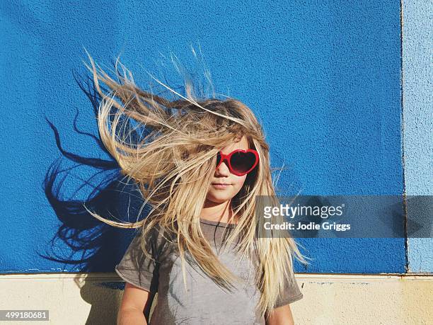 portrait of child with hair blowing in the wind - hair wind stock pictures, royalty-free photos & images