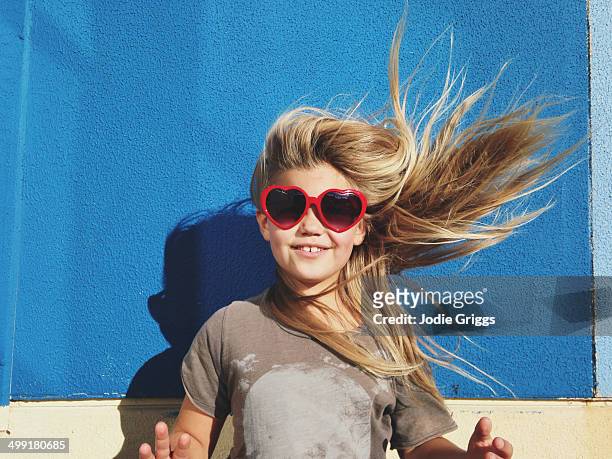 portrait of child with hair blowing in the wind - 8 9 years stock pictures, royalty-free photos & images