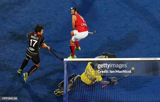 Thomas Briels of Belgium's shot beats Canadian goalkeeper David Carter during the match between Belgium and Canada on day three of The Hero Hockey...