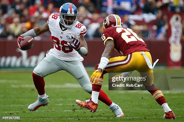 Wide receiver Hakeem Nicks of the New York Giants carries the ball against cornerback Bashaud Breeland of the Washington Redskins in the first...