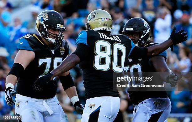 Julius Thomas of the Jacksonville Jaguars celebrates with Jermey Parnell and A.J. Cann after scoring a touchdown in the fourth quarter against the...