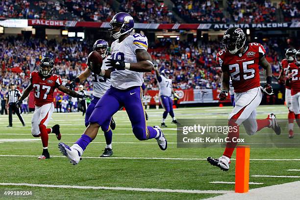 Adrian Peterson of the Minnesota Vikings scores a touchdown during the second half against the Atlanta Falcons at the Georgia Dome on November 29,...