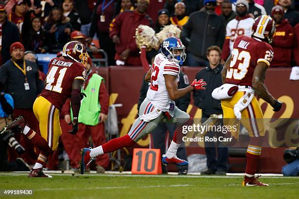 Wide receiver Rueben Randle of the New York Giants scores a fourth quarter touchdown past cornerback Will Blackmon of the Washington Redskins and...