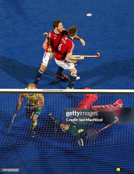 Henry Weir of Great Britain celebrates with Alan Forsyth of Great Britain after he scores during the match between Australia and Great Britain on day...