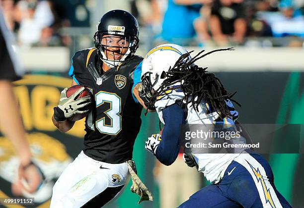 Rashad Greene of the Jacksonville Jaguars tries to avoid the tackle of Jason Verrett of the San Diego Chargers in the fourth quarter at EverBank...