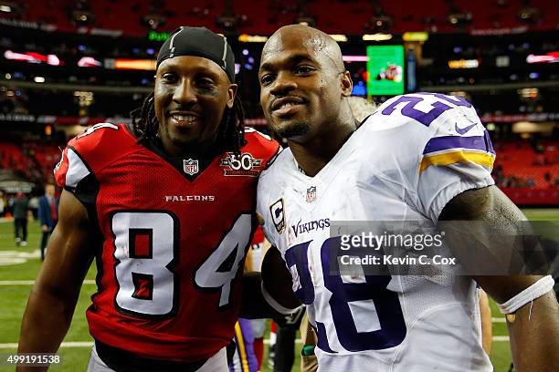 Adrian Peterson of the Minnesota Vikings shakes hands with Roddy White of the Atlanta Falcons after the game during the second half at the Georgia...