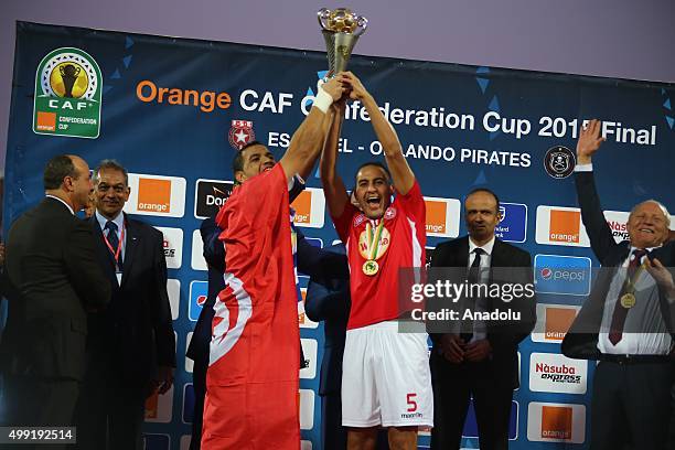 Captain of Etoile du Sahel Aymen Mathlouthi and Ammar Jemal , scorer of the winning goal, pose with the CAF trophy after defeating the Orlando...