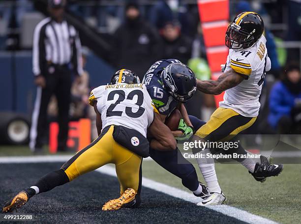 Wide receiver Jermaine Kearse of the Seattle Seahawks scores a touchdown after making a reception while defensive back Mike Mitchell of the...