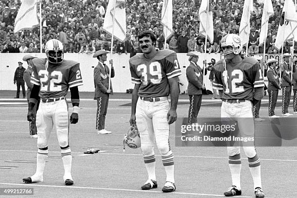 Running backs Mercury Morris, Larry Csonka, and quarterback Bob Griese of the Miami Dolphins stand on the field prior to Super Bowl VIII on January...
