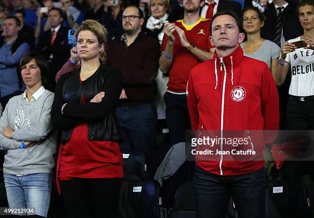 Former tennis champion Kim Clijsters and ping pong champion Jean-Michel Saive attend the victory of Andy Murray over David Goffin of Belgium during...