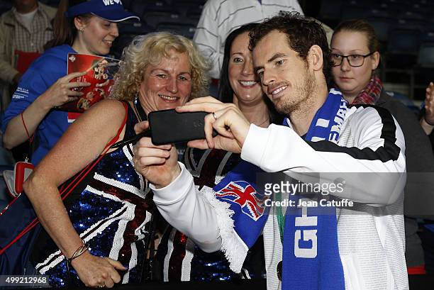 Andy Murray of Great Britain poses for a selfie with british fans on day three of the Davis Cup Final 2015 between Belgium and Great Britain at...