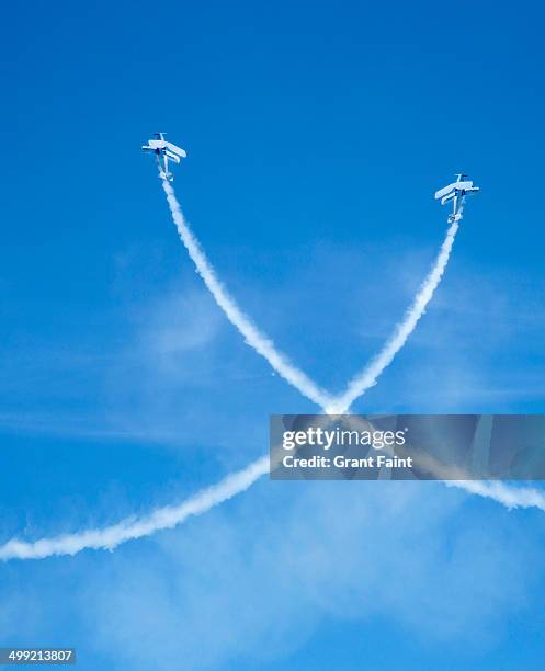 crossing airplanes at airshow. - vapour trail stock pictures, royalty-free photos & images