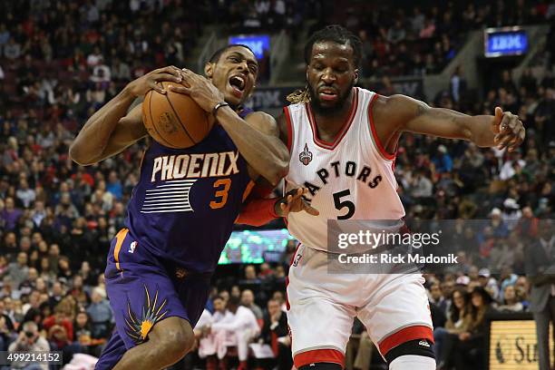 Phoenix Suns guard Brandon Knight drives against Toronto Raptors forward DeMarre Carroll . Toronto Raptors vs Phoenix Suns in 1st half action of NBA...