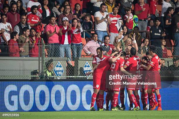 Fernando Uribe celebrates with his teammates after scoring the opening goal during the quarterfinals second leg match between Toluca and Puebla as...