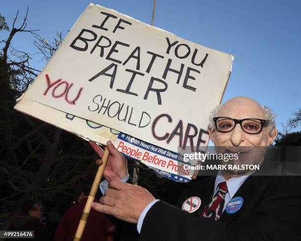 Man in a Bernie Sanders mask joins other environmental activists and supporters during a rally calling for action on climate change in Los Angeles,...