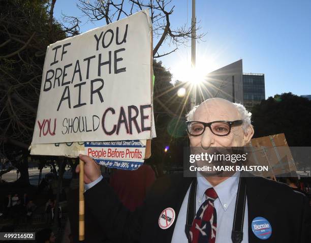 Man in a Bernie Sanders mask joins other environmental activists and supporters during a rally calling for action on climate change in Los Angeles,...