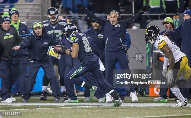 Wide receiver Doug Baldwin of the Seattle Seahawks runs to the end zone for an 80-yard touchdown reception as he is chased by defensive back Antwon...