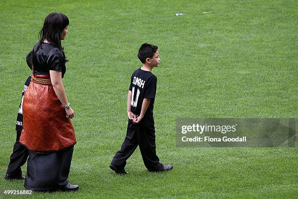 Nadene Lomu walks with her sons after the hearse as it leaves the service at the Public Memorial for Jonah Lomu at Eden Park on November 30, 2015 in...