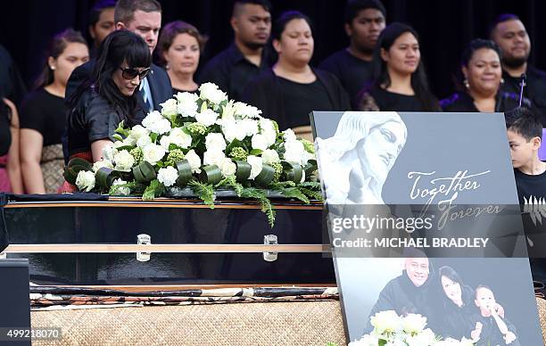 Widow of late New Zealand All Blacks rugby legend Jonah Lomu, Nadene Lomu walks past his casket during a memorial service at Eden Park in Auckland on...