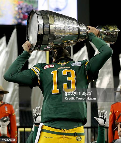 Mike Reilly of the Edmonton Eskimos holds the Grey Cup after the team defeated the Ottawa Redblacks at Investors Group Field during Grey Cup 103 on...