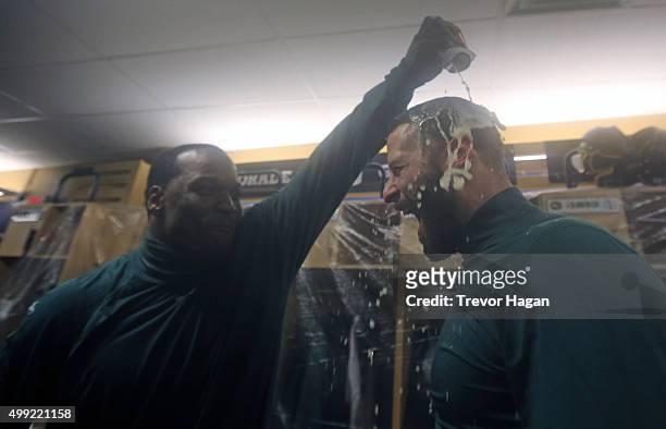 Odell Willis of the Edmonton Eskimos pours beer on Mike Reilly while celebrating in the locker room after winning Grey Cup 103 against the Ottawa...