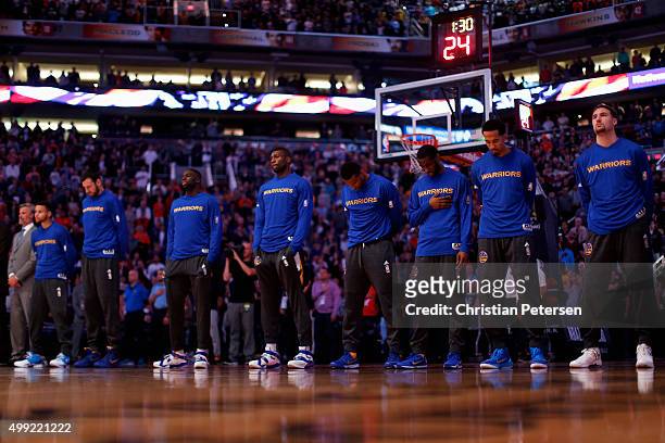 The Golden State Warriors stand attended for the national anthem before the NBA game against the Phoenix Suns at Talking Stick Resort Arena on...