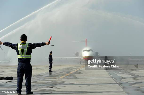 Water canons celebrate the arrival of the ARJ21 jet at the airport on November 29, 2015 in Chengdu, China. It is the first ARJ, a regional jet made...