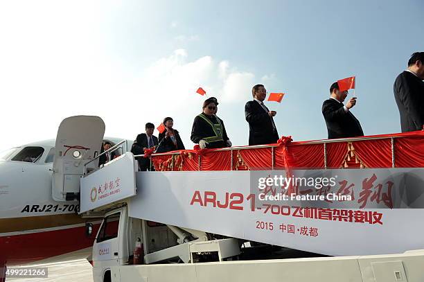 Staff celebrate the arrival of the ARJ21 jet at the airport on November 29, 2015 in Chengdu, China. It is the first ARJ, a regional jet made by...