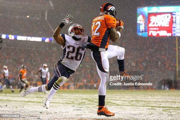Wide receiver Andre Caldwell of the Denver Broncos scores a fourth quarter touchdown past cornerback Logan Ryan of the New England Patriots at Sports...