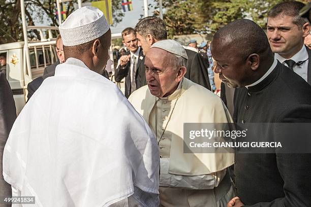 Pope Francis is greet by Central Mosque Imam Nehedid Tidjani , upon his arrival in the PK5 neighborhood on November 30, 2015 in Bangui. Pope Francis...