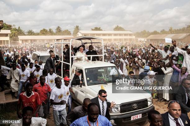 Pope Francis waves as he visit the Koudoukou school to meet people from the muslim community after leaving the Central Mosque in the PK5 neighborhood...