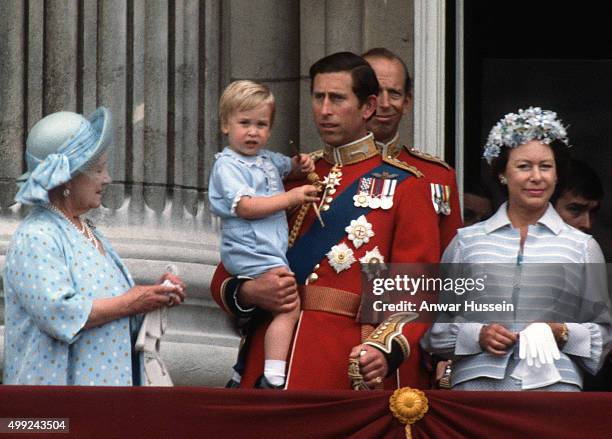 Prince Charles, Prince of Wales holds young Prince William on the balcony of Buckingham Palace following the Trooping the Colour ceremony on June 16,...