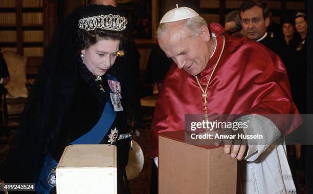 Queen Elizabeth ll exchanges gifts with Pope John Paul ll during her first visit to The Vatican on October 17, 1980 at Vatican City.