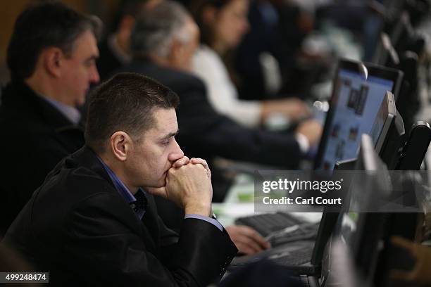 Journalist views a computer screen in the media room at the United Nations Climate Summit on November 30, 2015 in Paris, France. Political leaders...
