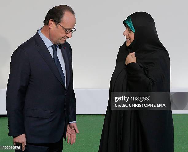 French President Francois Hollande greets Iran's Vice President Masoumeh Ebtekar as she arrives for the COP21 United Nations Climate Change...