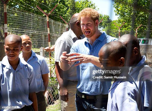 Prince Harry meets children as he visits Ottery Youth Centre, a rehabilitation centre for children linked to gang related crimes, during an official...