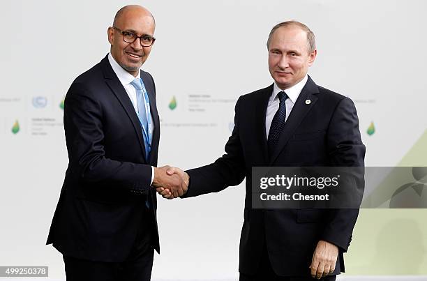 Harlem Desir, French Minister of State for European affairs welcomes Russian President Vladimir Putin as he arrives for the COP21 United Nations...