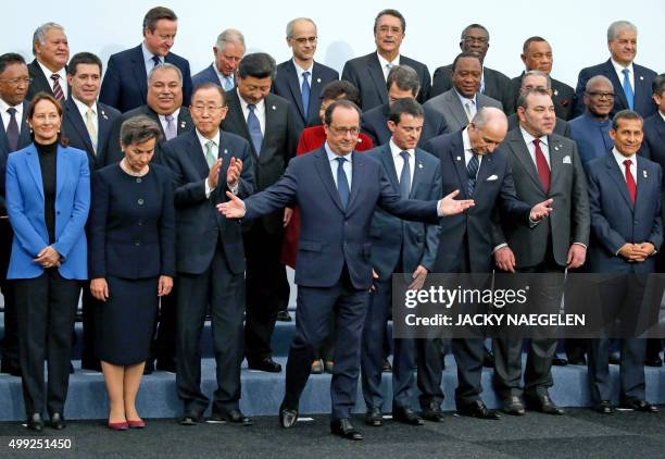 French President Francois Hollande gestures when posing with world leaders for a photo during the opening day of the World Climate Change Conference...