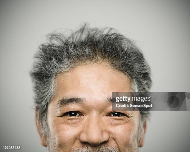 portrait of a happy real japanese man with grey hair. - smiling mature eyes stockfoto's en -beelden