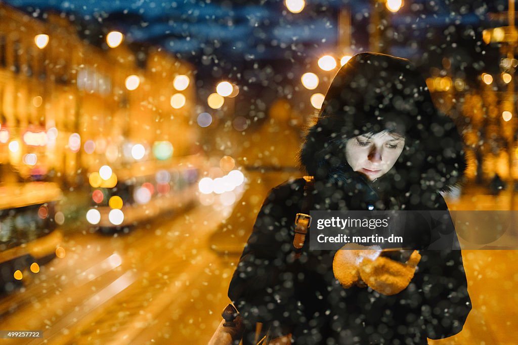 Woman texting at the street