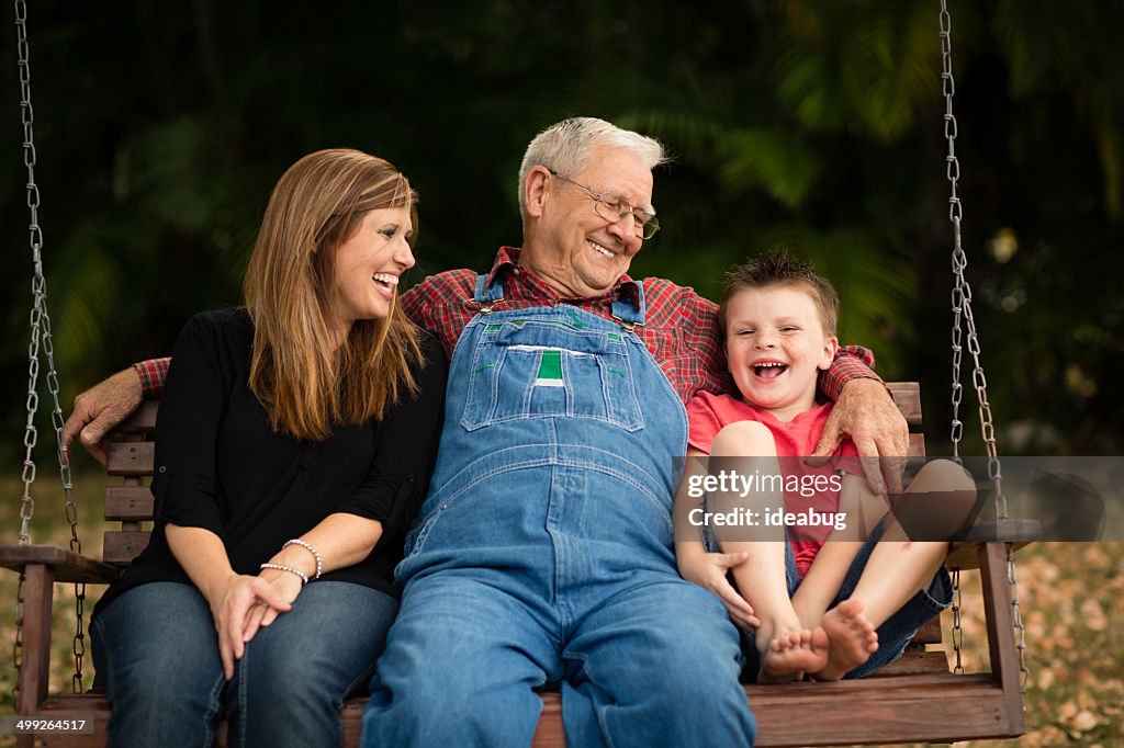 Grandpa Swinging With His Granddaughter and Great Grandson