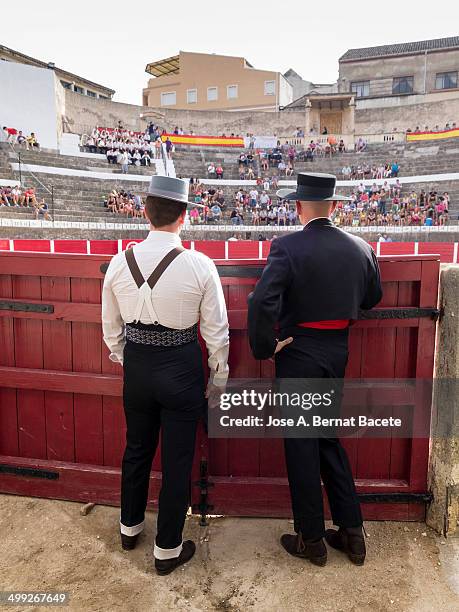 Two assistants of bullfighters dressed in outdoor suit. Bocairent, , Spain.