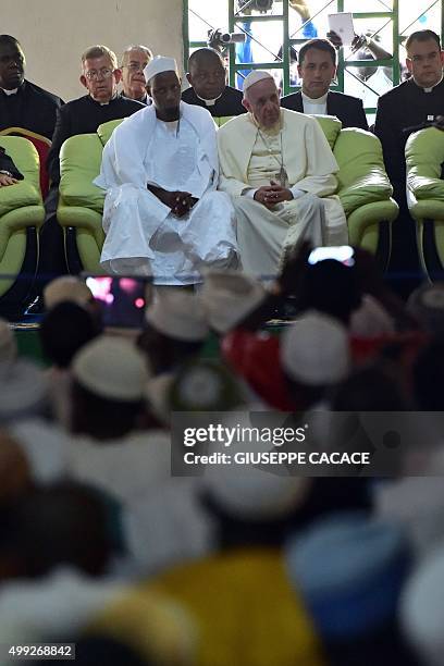 Pope Francis looks on, alongside Imam Nehedid Tidjani , during a visit to the Central Mosque in Bangui on November 30, 2015. Pope Francis said on...